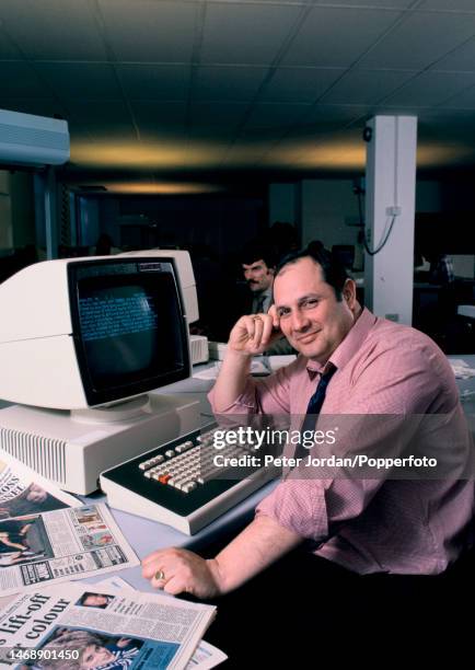 English businessman, publisher and newspaper owner Eddie Shah seated at a computer terminal in the newsroom of the Today national newspaper in London...