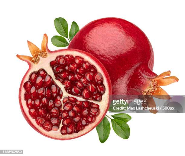 close-up of pomegranates against white background - half complete stock pictures, royalty-free photos & images