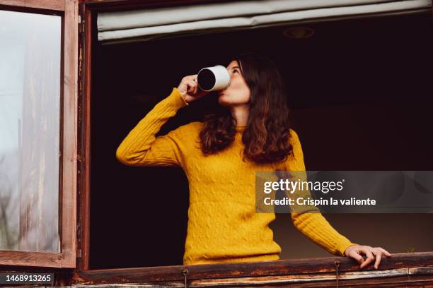 close up of a young woman having a cup of coffee in the morning - redneck women stock pictures, royalty-free photos & images