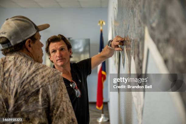 Community members Randy Edwards and Byer Junfin map water routes along the Rio Grande during a board meeting at the Maverick County Control and...