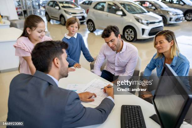 family discussing the terms of a lease agreement with the salesman - generation contract stock pictures, royalty-free photos & images