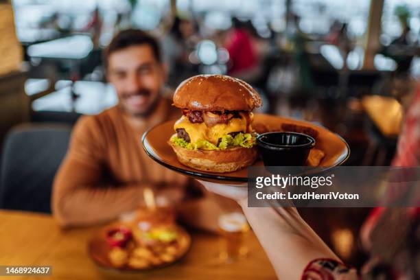 serving burger - hamburger restaurant stock pictures, royalty-free photos & images