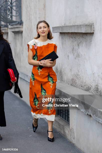 Jenny Walton wears orange white dress with print, pointed heels outside Prada during the Milan Fashion Week Womenswear Fall/Winter 2023/2024 on...