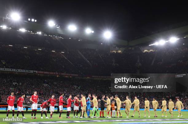 Manchester United and FC Barcelona players shake hands prior to the UEFA Europa League knockout round play-off leg two match between Manchester...