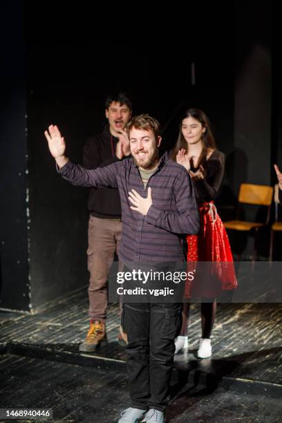 actor taking a bow on stage after performance - actor taking a bow stock pictures, royalty-free photos & images