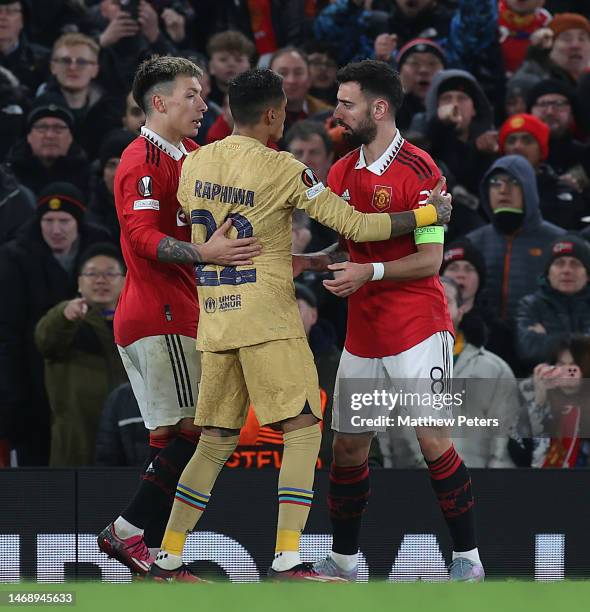 Lisandro Martinez and Bruno Fernandes of Manchester United clashes with Raphinha of Barcelona during the UEFA Europa League knockout round play-off...