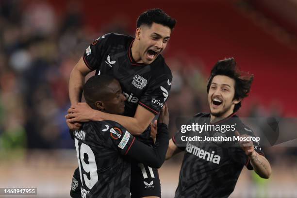 Moussa Diaby of Bayer Leverkusen is mobbed by team mates Sardar Azmoun and Nadiem Amiri after scoring the winning penlaty in the shoot out of the...