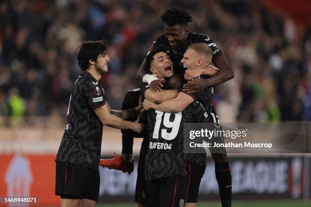 Moussa Diaby of Bayer Leverkusen is mobbed by team mates Sardar Azmoun, Edmond Tapsoba, Mitchel Bakker and Nadiem Amiri after scoring the winning...