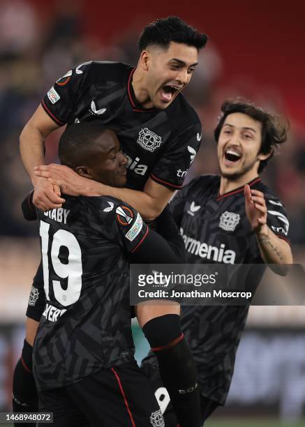 Moussa Diaby of Bayer Leverkusen is mobbed by team mates Sardar Azmoun and Nadiem Amiri after scoring the winning penlaty in the shoot out of the...