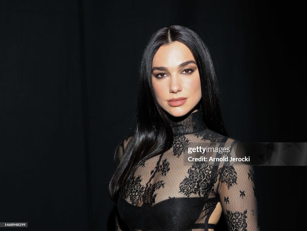 Dua Lipa poses backstage at the GCDS fashion show during the Milan