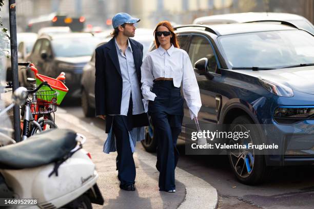 Js Roques is seen wearing a denim hat embellished with silver details, a diamond ring, a striped light blue shirt, a blue blazer, a blu skirt over...