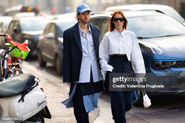 Js Roques is seen wearing a denim hat embellished with silver details, a diamond ring, a striped light blue shirt, a blue blazer, a blu skirt over...