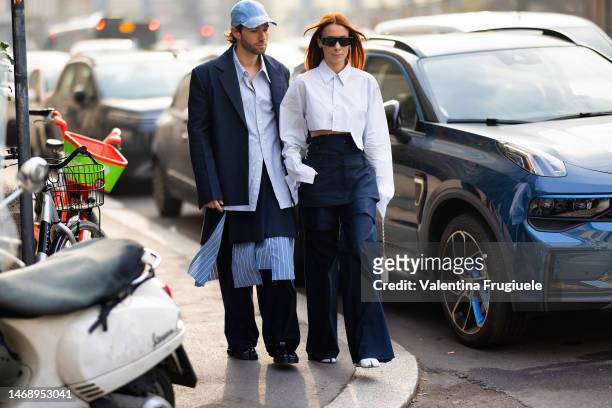 Js Roques is seen wearing a denim hat embellished with silver details, a diamond ring, a striped light blue shirt, a blue blazer, a blu skirt over...