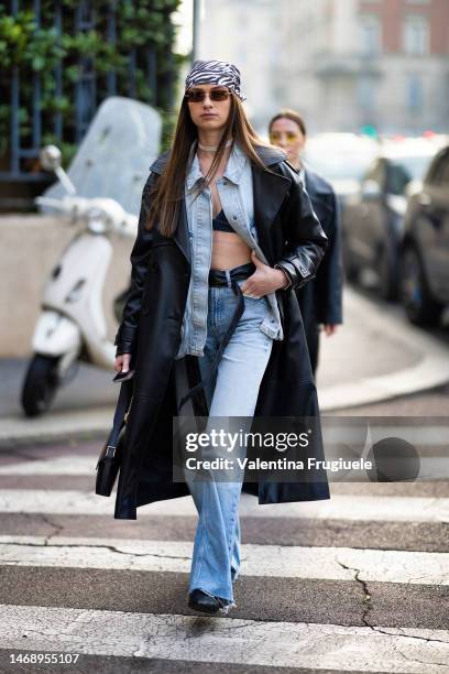 Guest is seen wearing white and black zebra print headscarf, black and silver sunglasses, a diamond choker, a black leather bag, black leather...