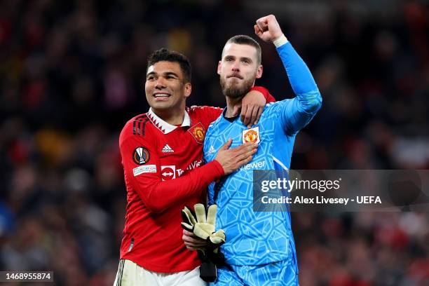 Casemiro and David De Gea of Manchester United celebrate victory following the UEFA Europa League knockout round play-off leg two match between...