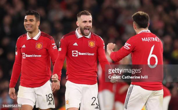 Luke Shaw of Manchester United celebrates victory with teammate Lisandro Martinez following the UEFA Europa League knockout round play-off leg two...