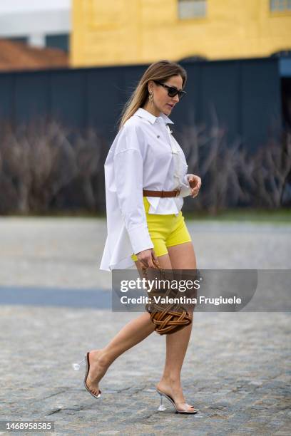 Singer Ginta is seen wearing YSL black sunglasses, long gold and diamonds earrings, a white oversized shirt with gold bottoms and different fabric...