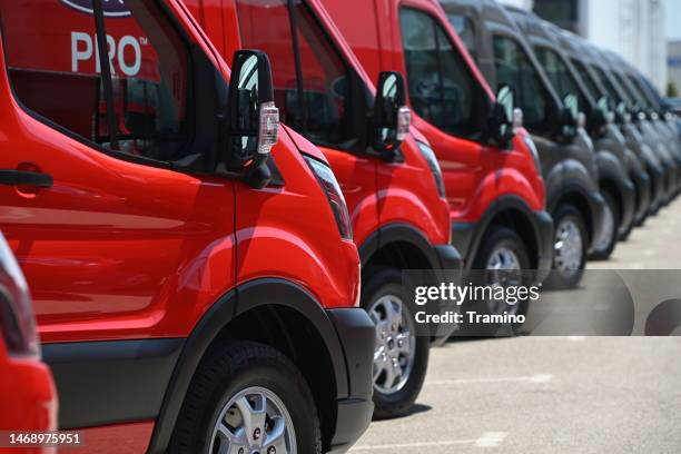 electric delivery vans parked on a parking - van depot stock pictures, royalty-free photos & images