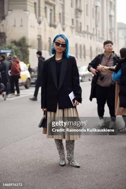 Guest is seen wearing blue hair, black and gold Fendi sunglasses, large circle silver JW Anderson earrings, gold rings, a gold chain necklace, and a...