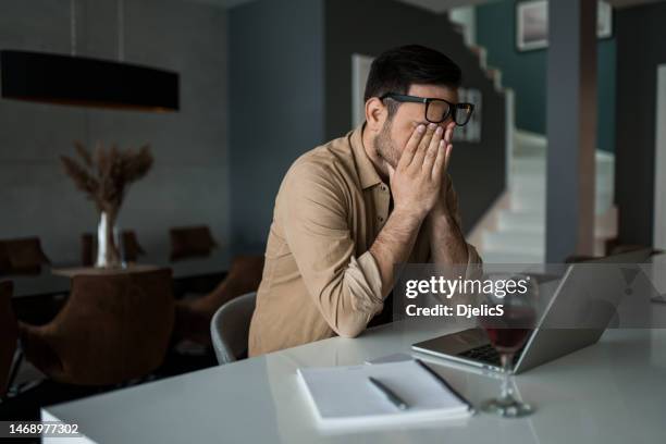 depressed young man covering face while failing at his business. - man cry touching stock pictures, royalty-free photos & images