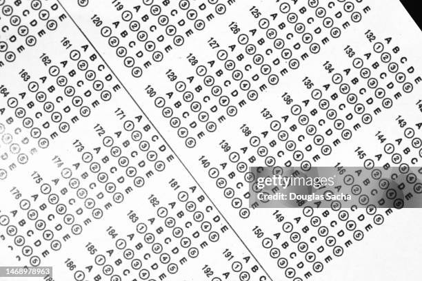 educational assessment and evaluation - marked sheet of paper imagens e fotografias de stock