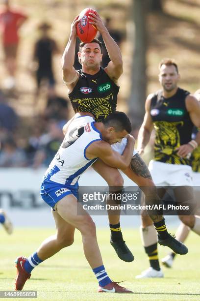 Tim Taranto of the Tigers is tackled by Luke Davies-Uniacke of the Kangaroos during the AFL Match Simulation between North Melbourne Kangaroos and...