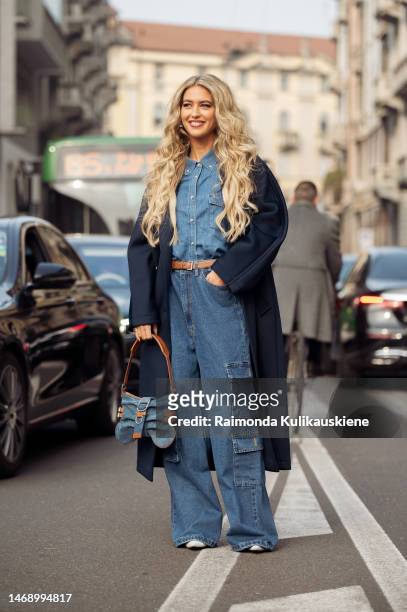 Emili Sindlev wears a navy coat, denim bag, denim shirt, wide leg pants with side pockets outside the Max Mara show during the Milan Fashion Week...