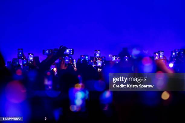 Concert-goers record and take photos with their smartphones during the Chris Brown "Under the Influence" Tour at AccorHotels Arena on February 23,...