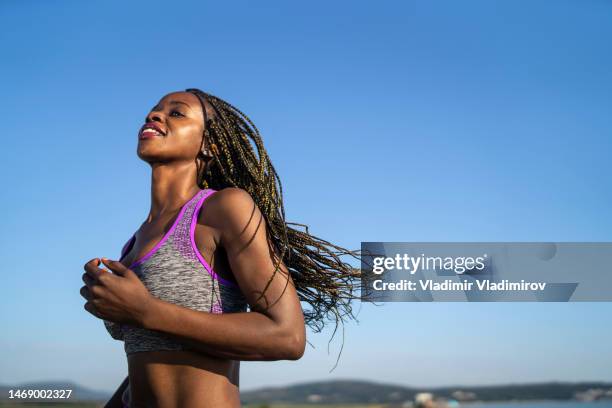 headshot of a woman jogging - woman marathon stock pictures, royalty-free photos & images