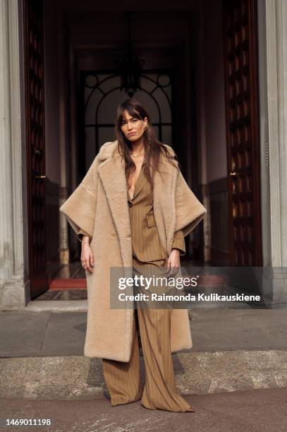 Guest is seen wearing a brown suit and brown long fluffy coat outside the Max Mara show during the Milan Fashion Week Womenswear Fall/Winter...