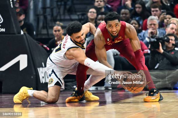 Jamal Murray of the Denver Nuggets tries for a steal from Donovan Mitchell of the Cleveland Cavaliers during the second quarter at Rocket Mortgage...