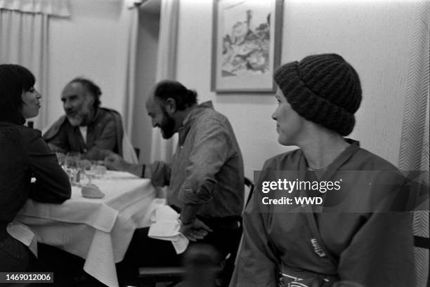 Guest, Michel Piccoli, Juan Luis Bunuel, and Liv Ullmann share a meal during production of 'Leonor' in Caceres, Spain, on November 20, 1974.