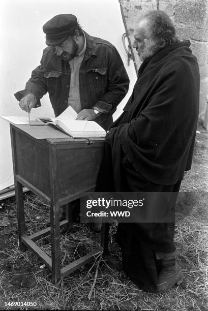 Juan Luis Bunuel consults with Michel Piccoli during production of 'Leonor' in Caceres, Spain, on November 20, 1974.