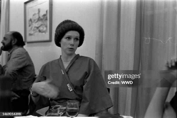 Juan Luis Bunuel and Liv Ullmann share a meal during production of 'Leonor' in Caceres, Spain, on November 20, 1974.