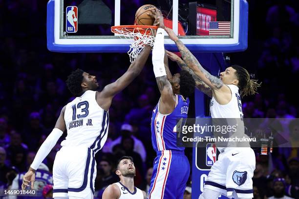Paul Reed of the Philadelphia 76ers dunks between Jaren Jackson Jr. #13 and Brandon Clarke of the Memphis Grizzlies during the second quarter at...