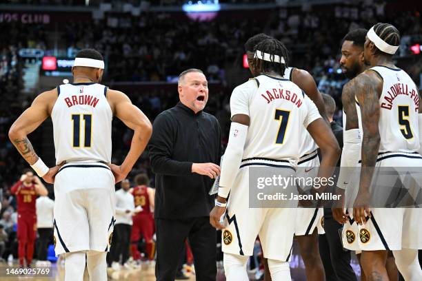 Head coach Michael Malone of the Denver Nuggets talks with his players during the fourth quarter against the Cleveland Cavaliers at Rocket Mortgage...