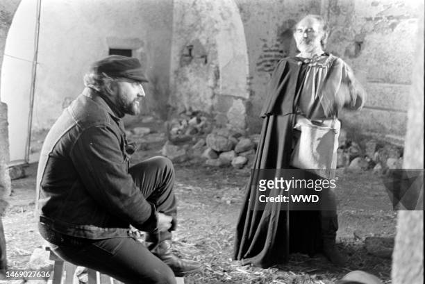 Juan Luis Bunuel and Michel Piccoli prepare for filming during production of 'Leonor' in Caceres, Spain, on November 20, 1974.