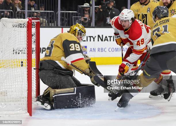Jakob Pelletier of the Calgary Flames scores a power-play goal against Laurent Brossoit of the Vegas Golden Knights in the first period of their game...