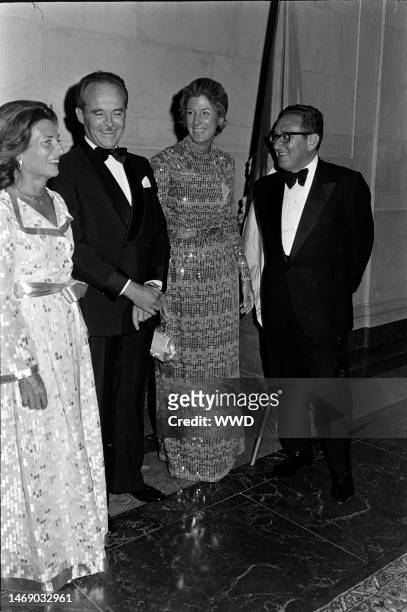 Lise-Marie Sauvagnargues, Nancy Kissinger, Jean Sauvagnargues, and Henry Kissinger attend a party at the National Gallery of Art in Washington, D.C.,...