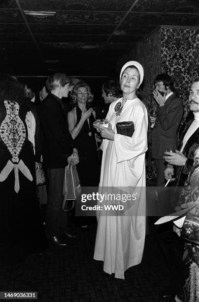 Andy Warhol, Sylvia Miles, and Lily Auchincloss attend Marisa Berenson's party for Liza Minnelli after the premiere of 'Cabaret' on Feb. 6, 1972.