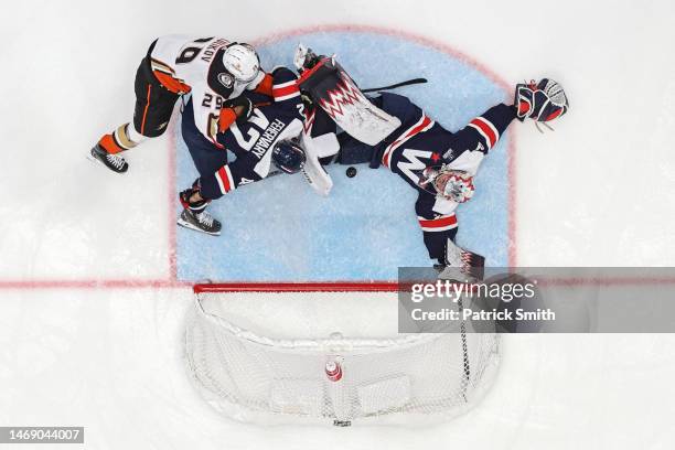 Goalie Charlie Lindgren of the Washington Capitals cannot make a save on a goal scored by Troy Terry of the Anaheim Ducks as players crash the net...