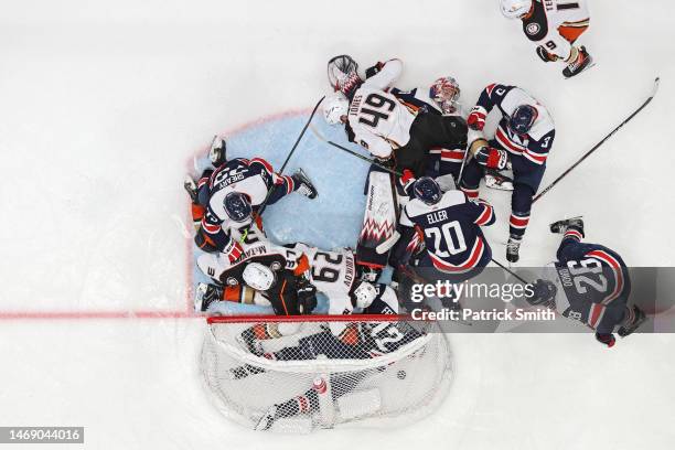 Goalie Charlie Lindgren of the Washington Capitals cannot make a save on a goal scored by Troy Terry of the Anaheim Ducks as players crash the net...