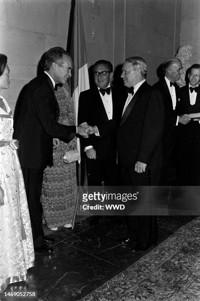 Lise-Marie Sauvagnargues, Jean Sauvagnargues, .Henry Kissinger, James Reston, and guests attend a party at the National Gallery of Art in Washington,...