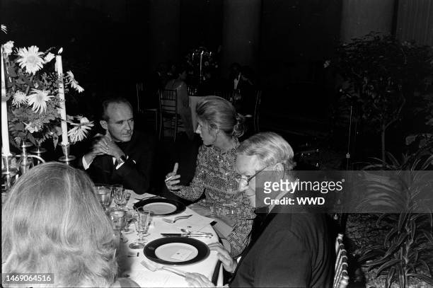 Jean Sauvagnargues, Nancy Kissinger, and James Reston attend a party at the National Gallery of Art in Washington, D.C., on September 27, 1974.