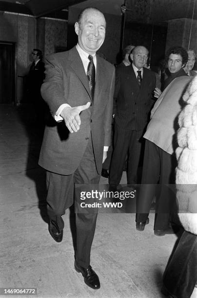 Gordon Franklin greets a guest outside of frame at a Fashion Capital of the World, Inc. Runway show in New York as Paul Honig and S.I. Newhouse, Jr....
