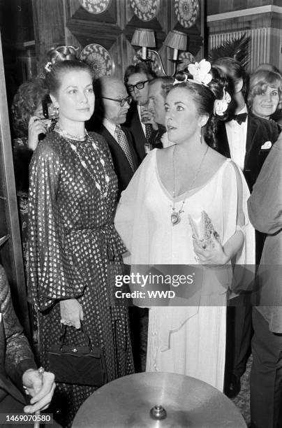 Grace Kelly and Elizabeth Taylor attend a party during Taylor's weekend-long 40th birthday celebration in Budapest, Hungary, on Feb. 26-27, 1972.