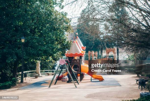 colorful kids outdoor playground equipment with slides - speeltuintoestellen stockfoto's en -beelden