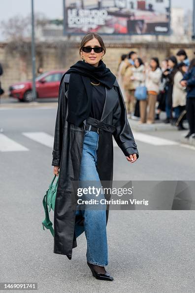 Darja Barannik wears black leather coat, green bag, denim jeans ...