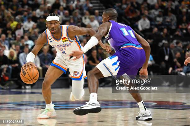 Shai Gilgeous-Alexander of the Oklahoma City Thunder drives past Kris Dunn of the Utah Jazz during the second half of a game at Vivint Arena on...