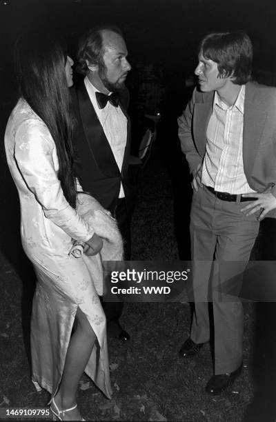 Kedakai Turner, James Lipton, and James Earl 'Chip' Carter attend a party honoring Shirley MacLaine in Washington, D.C., on May 17, 1977.